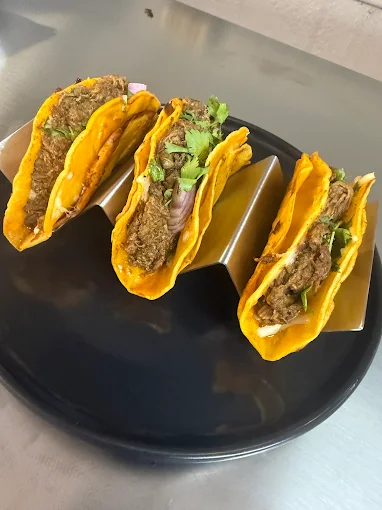 A plate of House of Birría tacos